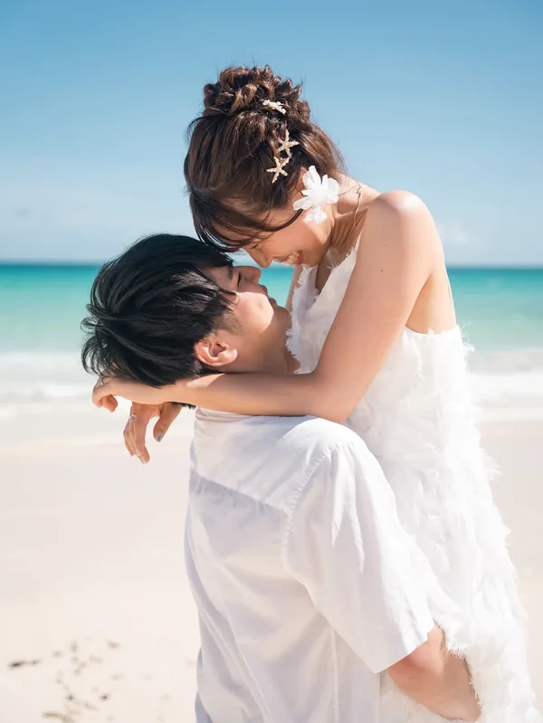 海辺で抱き合い、見つめ合うふたり